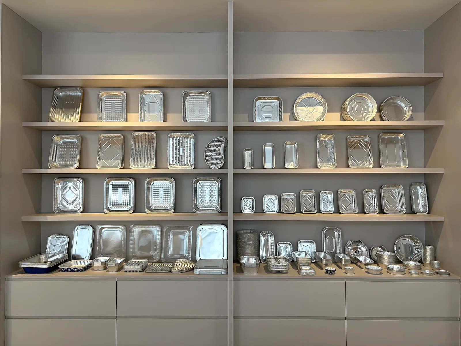 Aluminum foil trays and containers arranged on showroom shelves