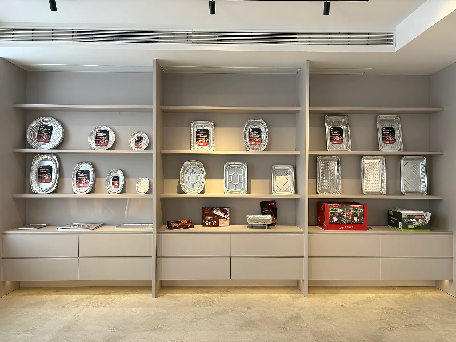 Packaged aluminum foil pan samples displayed on shelves