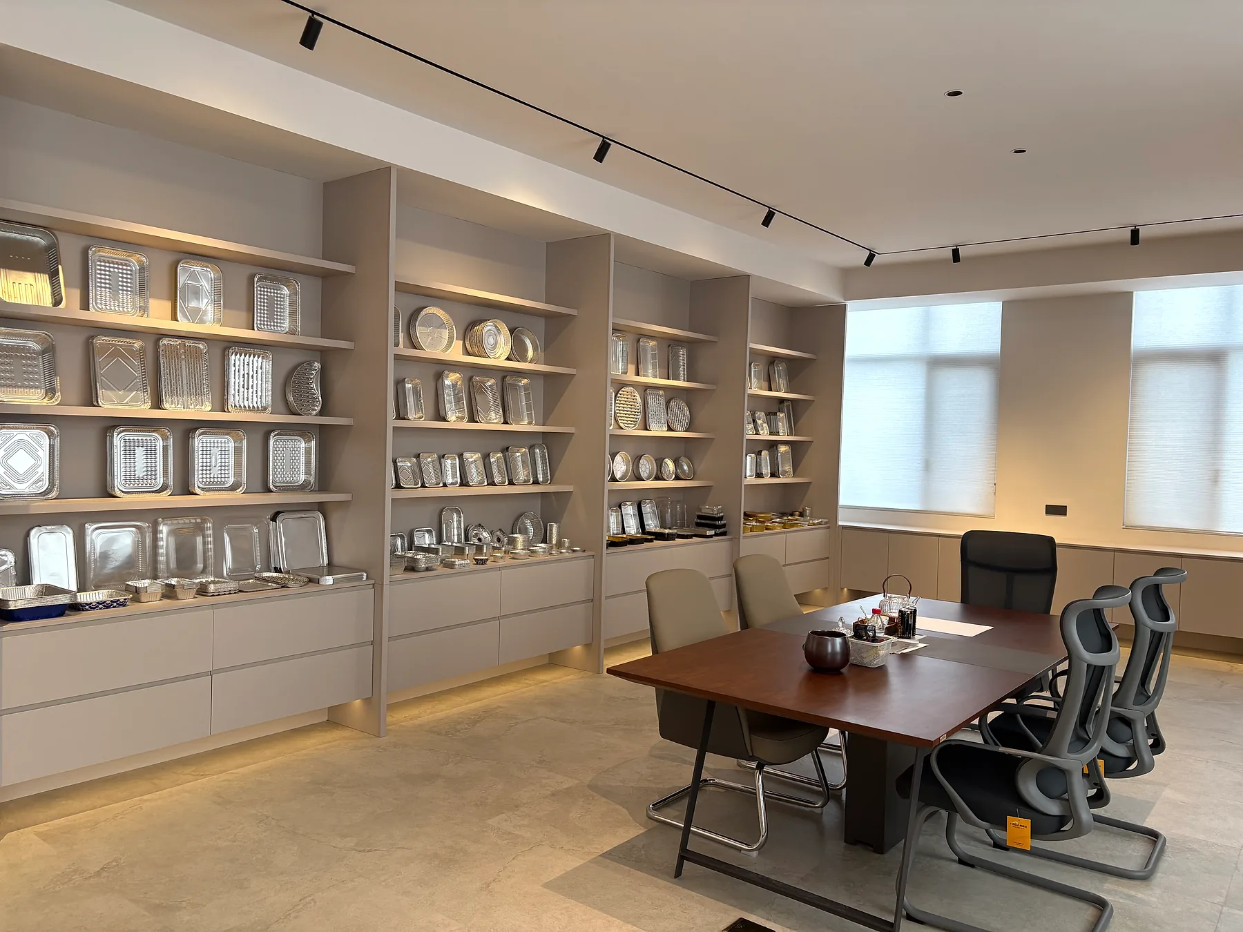 Aluminum foil product showroom with sample walls and meeting table